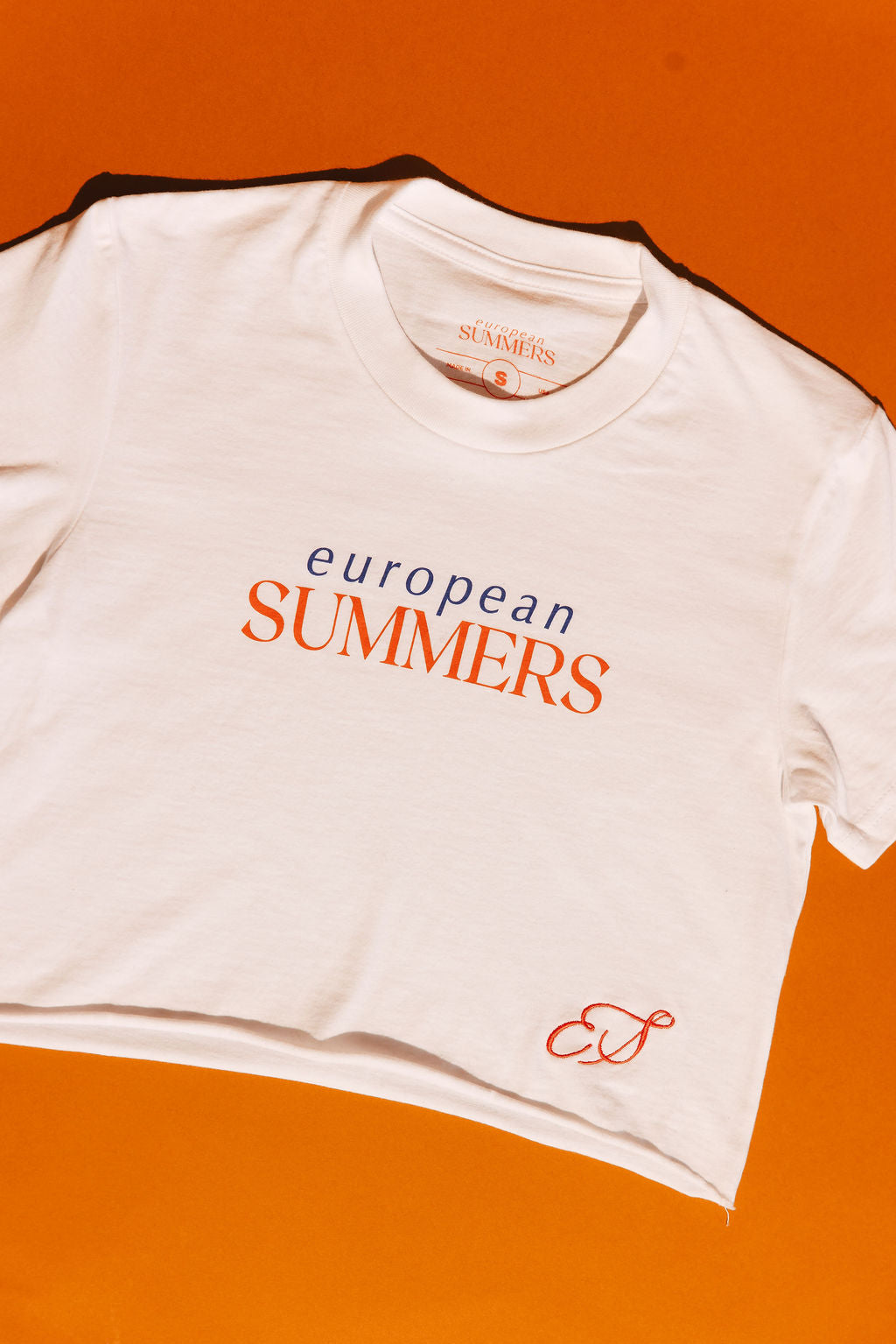White t-shirt with 'European Summers' text on an orange background