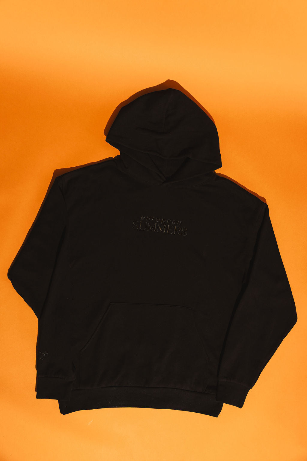 Black hoodie with European Summers text on an orange background