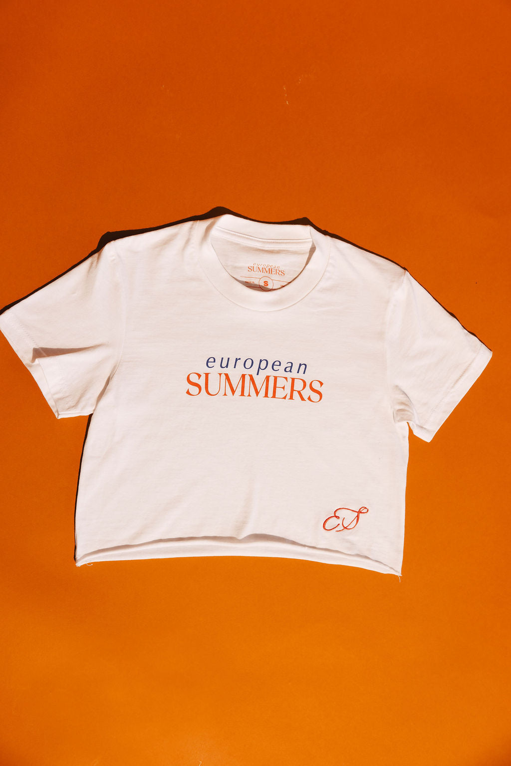 White t-shirt with 'European Summers' text on an orange background
